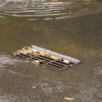 Rainwater drainage or storm grille closeup during a downpour